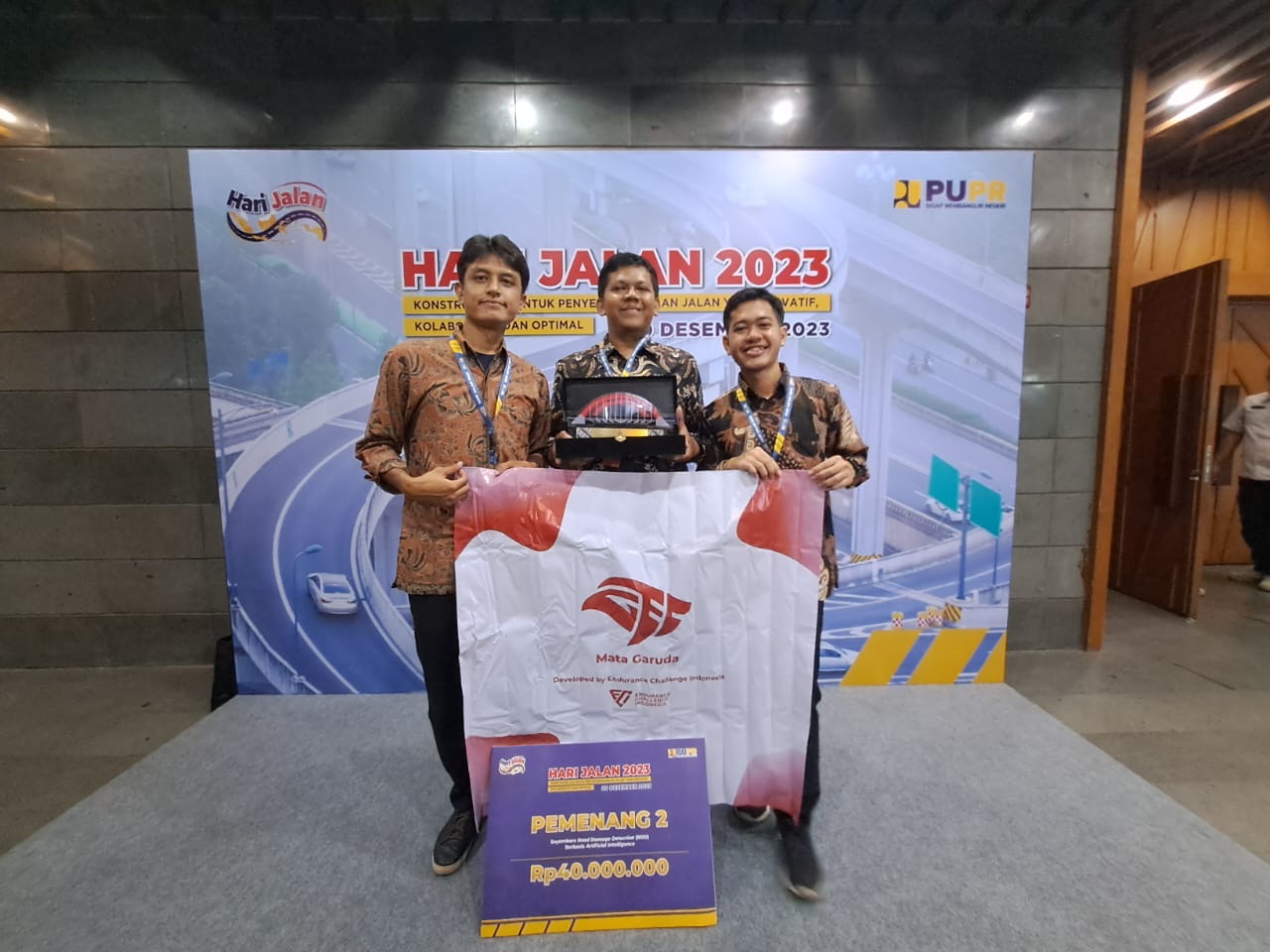 Mata Garuda team holding the trophy and team banner